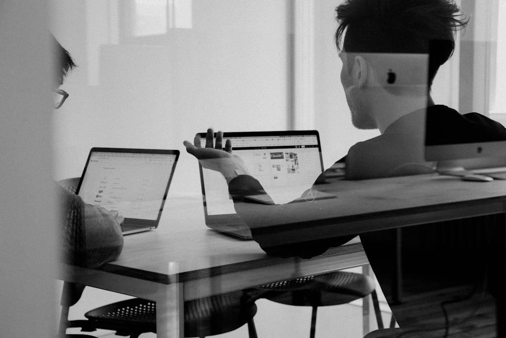 Professional signing digital documents on a tablet at a desk