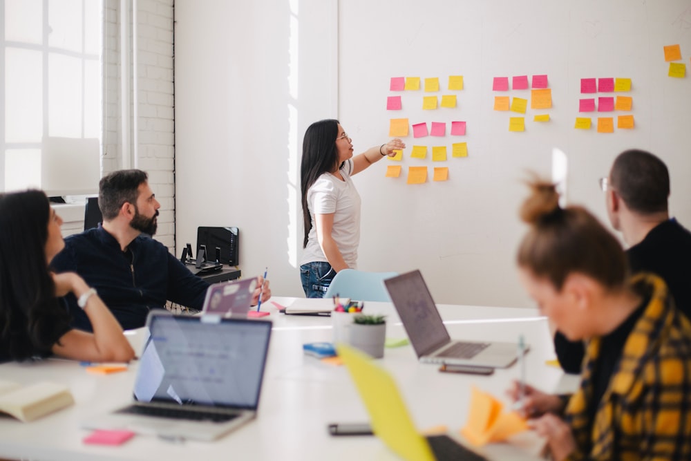 Sticky notes and draft labels organizing confidential document review