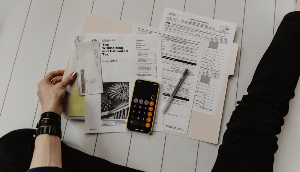Close-up of paperwork, charts, and a calculator on a desk